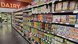 sweeping view of stocked shelves, with the Dairy section in the background